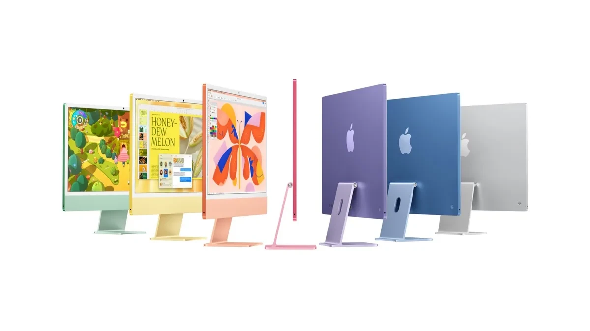 Desain Apple iMac 24 inci warna warni di atas meja kerja