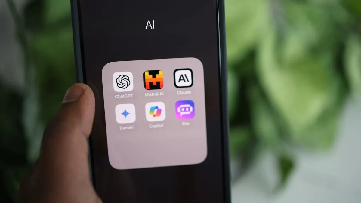 Ponsel menampilkan folder aplikasi AI berisi Google Gemini, ChatGPT, dan Claude