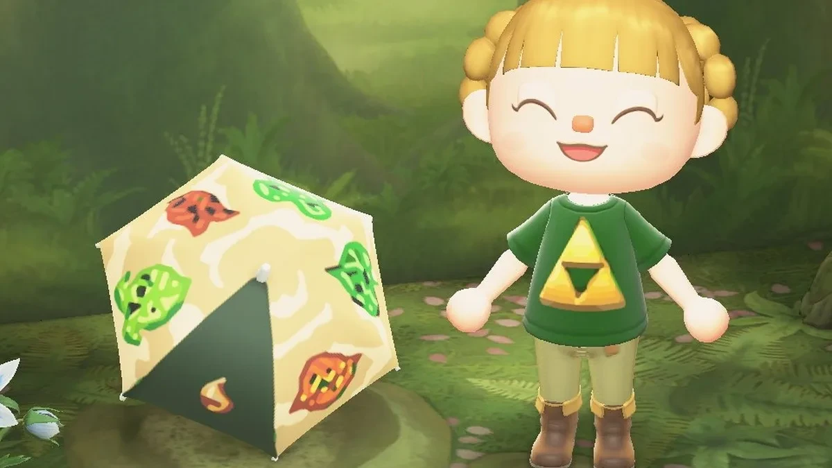 Karakter Animal Crossing New Horizons mengenakan kaus Triforce Tee dan memegang payung Korok Umbrella